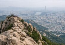 Rocky summit view of Gwanaksan overlooking Seoul on a hazy day