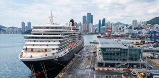 Why Busan, Incheon and Jeju Have Not Become True Cruise Hubs A large cruise ship docked at a modern Korean port terminal with a city skyline and harbor facilities in the background