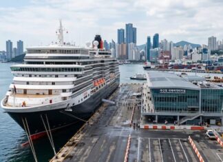 Why Busan, Incheon and Jeju Have Not Become True Cruise Hubs A large cruise ship docked at a modern Korean port terminal with a city skyline and harbor facilities in the background