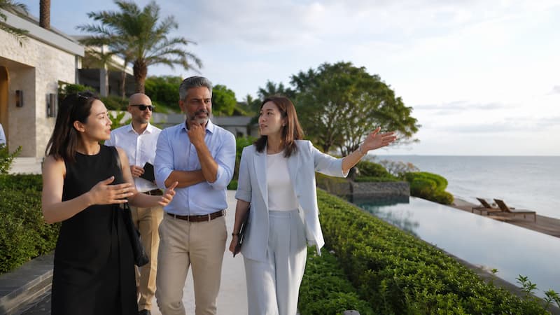 A destination inspection team walking through a resort while discussing suitability for Korean travellers