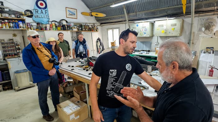 Malta Aviation Museum restoration workshop with guide and visitors