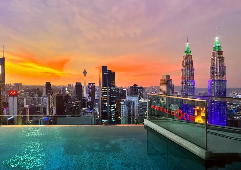 Sunset over Kuala Lumpur with the Petronas Twin Towers viewed from the Imperial Lexis Kuala Lumpur infinity pool