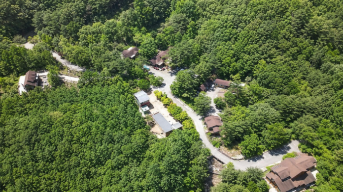 chuncheon-yonghwasan-recreation-forest-aerial-view 울창한 숲속에 숙박동과 관리시설이 자리한 춘천 용화산자연휴양림 전경