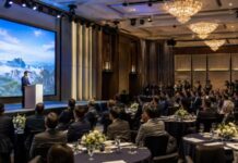 A formal tourism promotion event for travel industry representatives in a luxury hotel ballroom