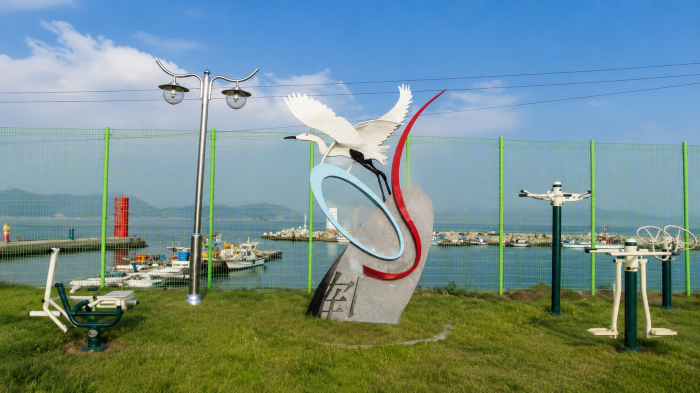 거제 이수도 항구 앞 학 조형물과 어선 풍경