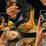 Social media creators filming food while a journalist records information at a tourism event