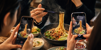 Social media creators filming food while a journalist records information at a tourism event