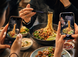 When the influencer becomes the attraction: What tourism marketing may be getting wrong Social media creators filming food while a journalist records information at a tourism event